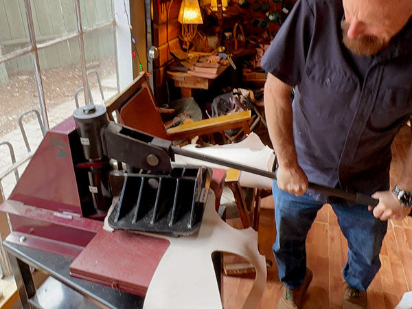 Person using the eight-ton leather clicker press